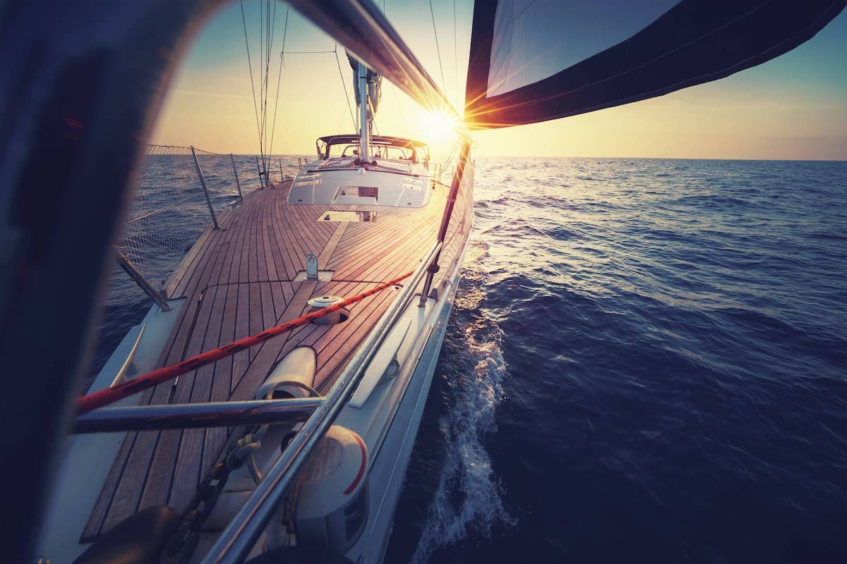 sail boat up close with the sunset behind it-1